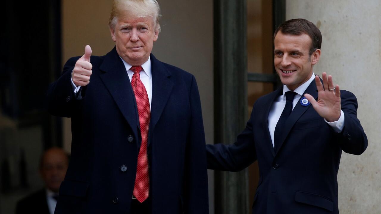 French President Emmanuel Macron welcomes US President Donald Trump as he arrives at the Elysee Palace in Paris